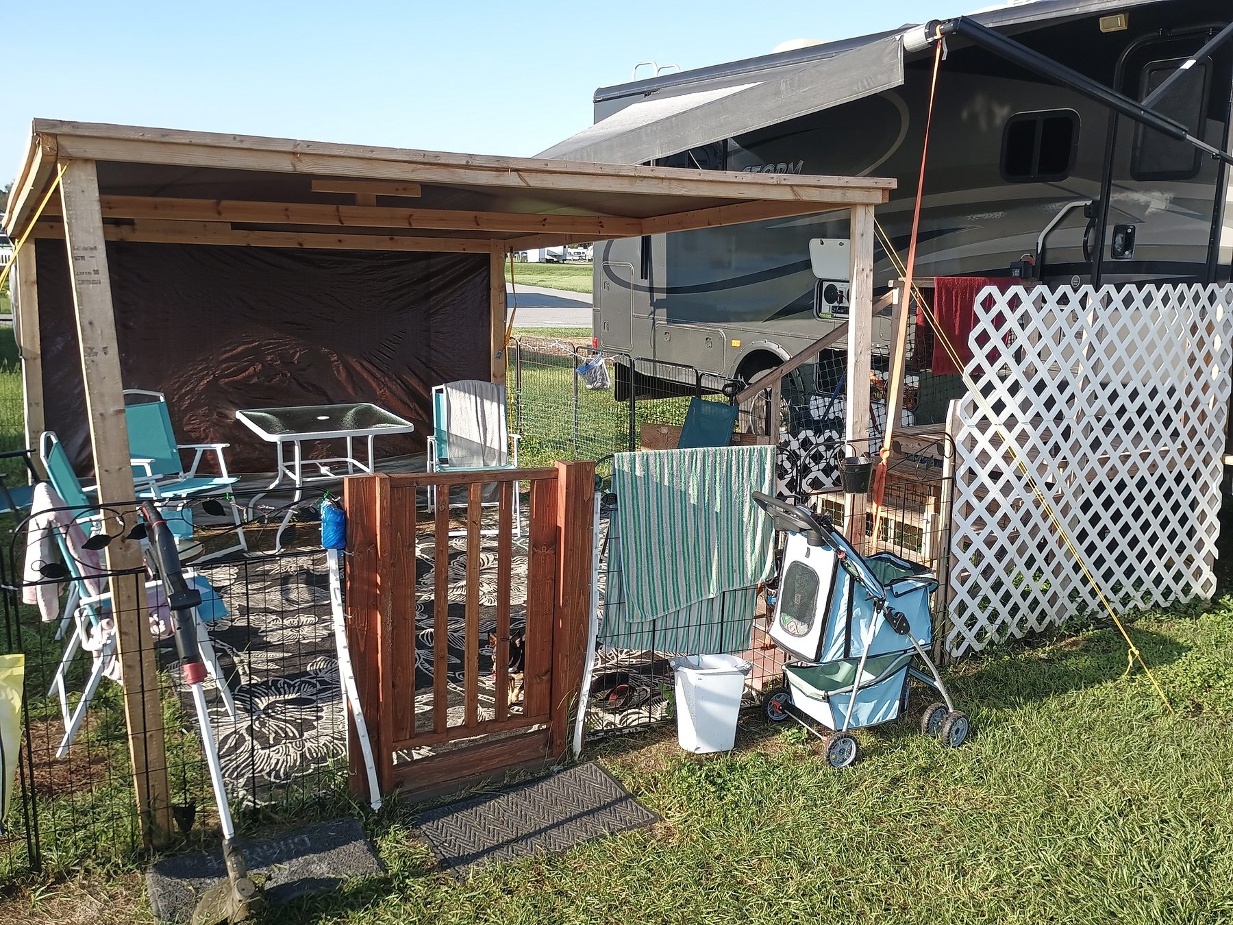 Ted's handcrafted awning and deck setup at the RV lot